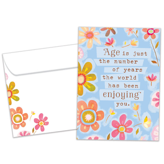 Front view of a Birthday greeting card featuring pastel-colored flowers surrounding a message about age being just a number, with a matching envelope.