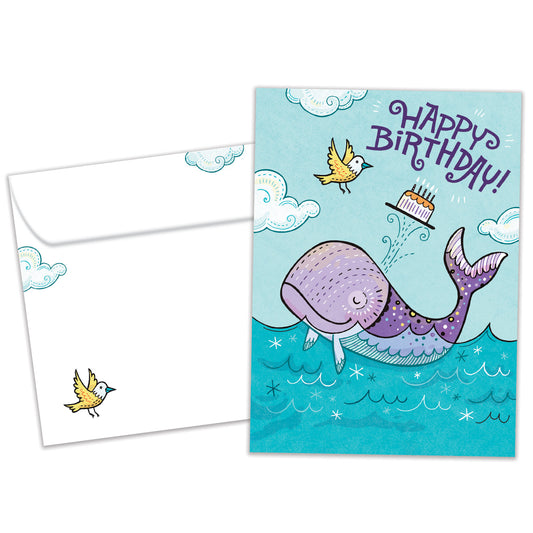 Front view of a Birthday greeting card featuring a playful illustration of a purple whale with a happy birthday message, with a matching envelope.