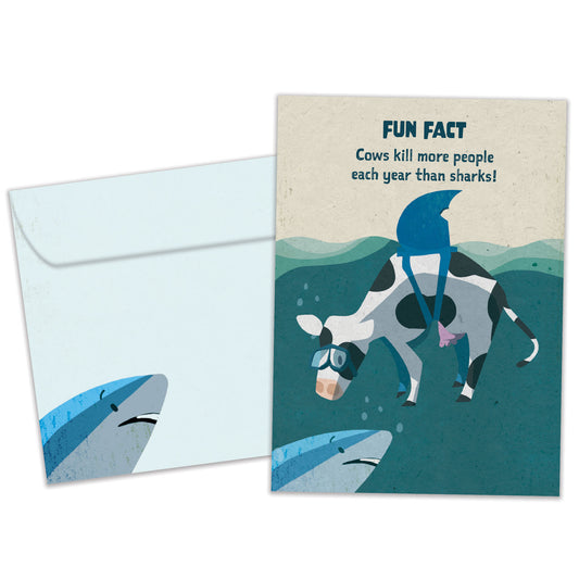 Front view of a Birthday greeting card featuring a cow with a shark’s fin and a fun fact about cows and sharks, with a matching envelope.