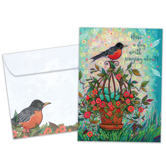 Front view of a birthday greeting card featuring a colourful illustration of a robin with the message "have a day worth singing about", with a matching envelope.
