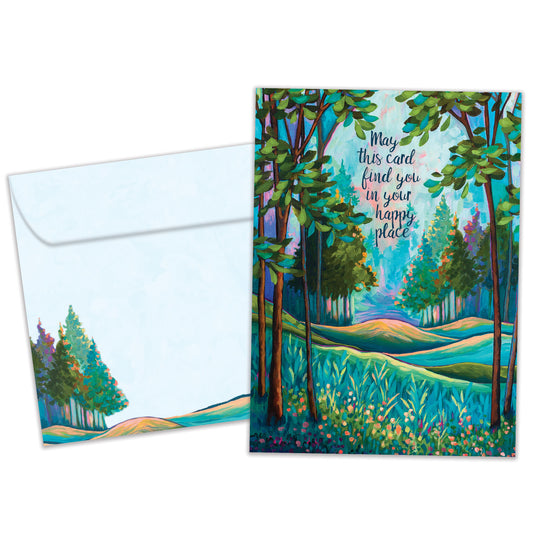 Front view of a birthday greeting card featuring an illustration of a tranquil forest with a message about finding your happy place, with a matching envelope.