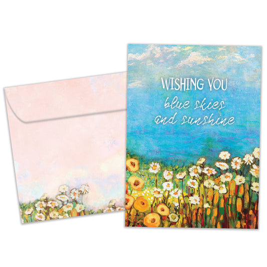 Front view of a birthday greeting card featuring the message "wishing you blue skies and sunshine" with an illustration of blue skies and flowers, with a matching envelope.
