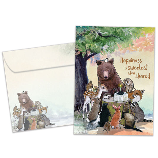 Front view of a Birthday greeting card featuring animals sitting around a birthday cake and a message about sharing, with a matching envelope