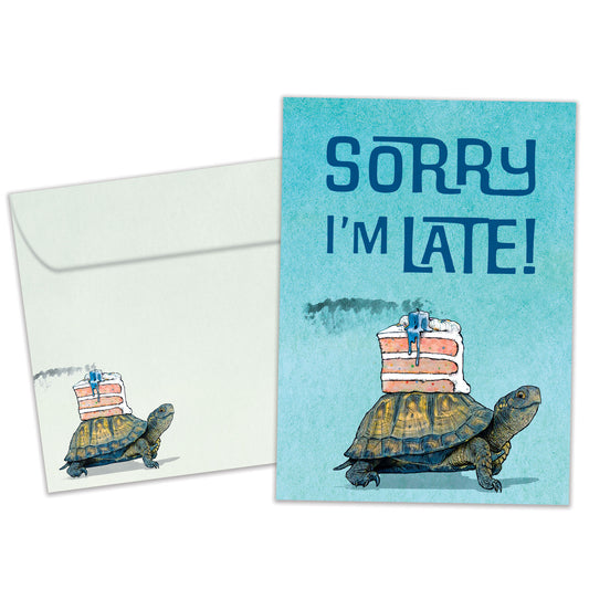 Front view of a Birthday greeting card featuring a turtle with a cake on it’s back and the message "Sorry I’m late", with a matching envelope.