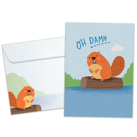 Front view of a Birthday greeting card featuring a beaver floating on a log with the message "oh damn", with a matching envelope.
