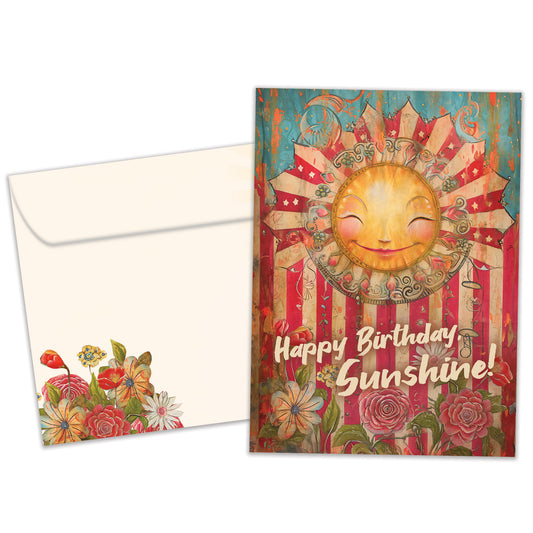 Front view of a Birthday greeting card featuring a smiling sun and floral design and the message "Happy Birthday Sunshine!", with a matching envelope