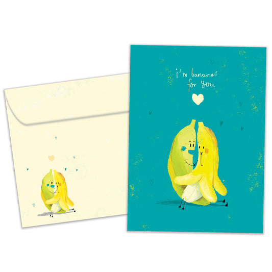 Front view of an Anniversary greeting card and matching envelope featuring two bananas hugging on a teal background with a loving message.