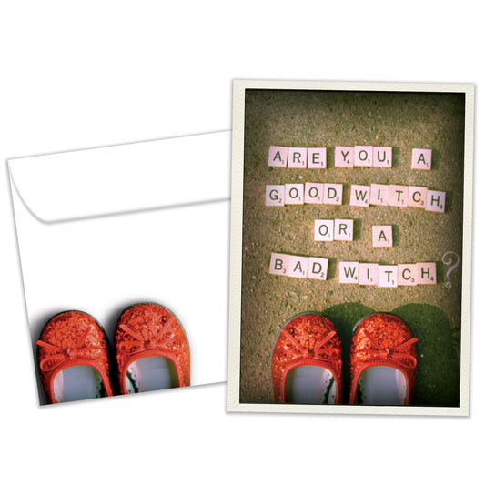 Front view of a Birthday greeting card and matching envelope featuring red ruby shoes and a message about good witch or bad witch.