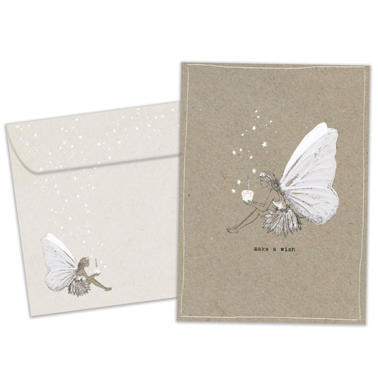 Front view of a Birthday greeting card and matching envelope featuring a dainty fairy holding a cupcake with the message "make a wish."
