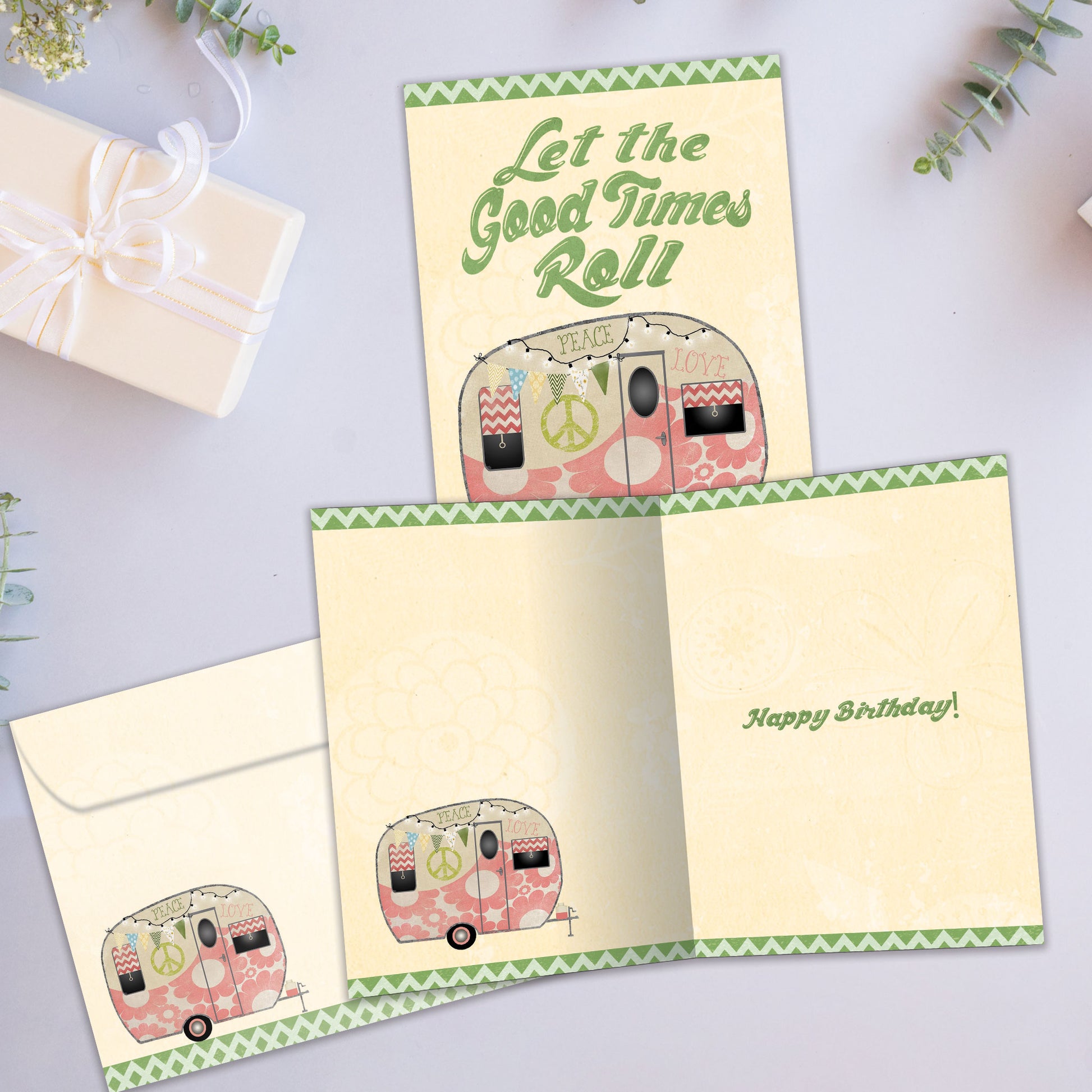 Front and inside view of a birthday greeting card showcasing an illustration of a camper trailer and the message "Let the good times roll", with a matching envelope.