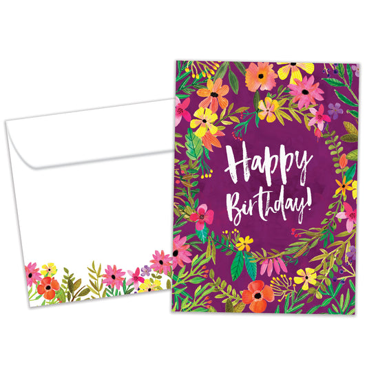 Front view of a birthday greeting card featuring "Happy Birthday" surrounded by flowers on a purple background, with a matching envelope.