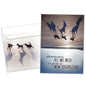Front view of a birthday greeting card featuring an upside-down image of dogs on a beach with a message about perspective, with a matching envelope.