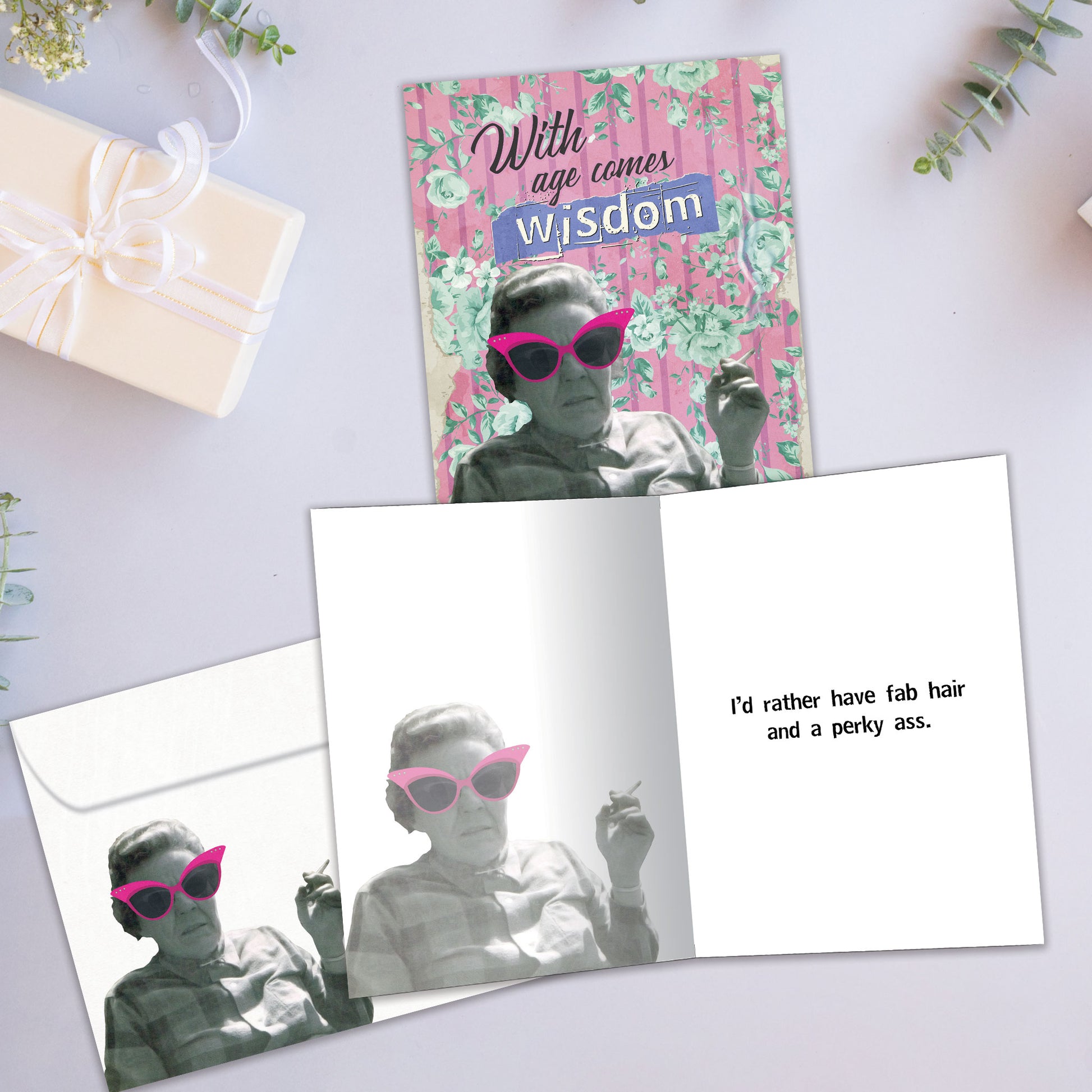 Front and inside view of a Birthday greeting card showcasing an old lady smoking with a message about wisdom and age, with a matching envelope.