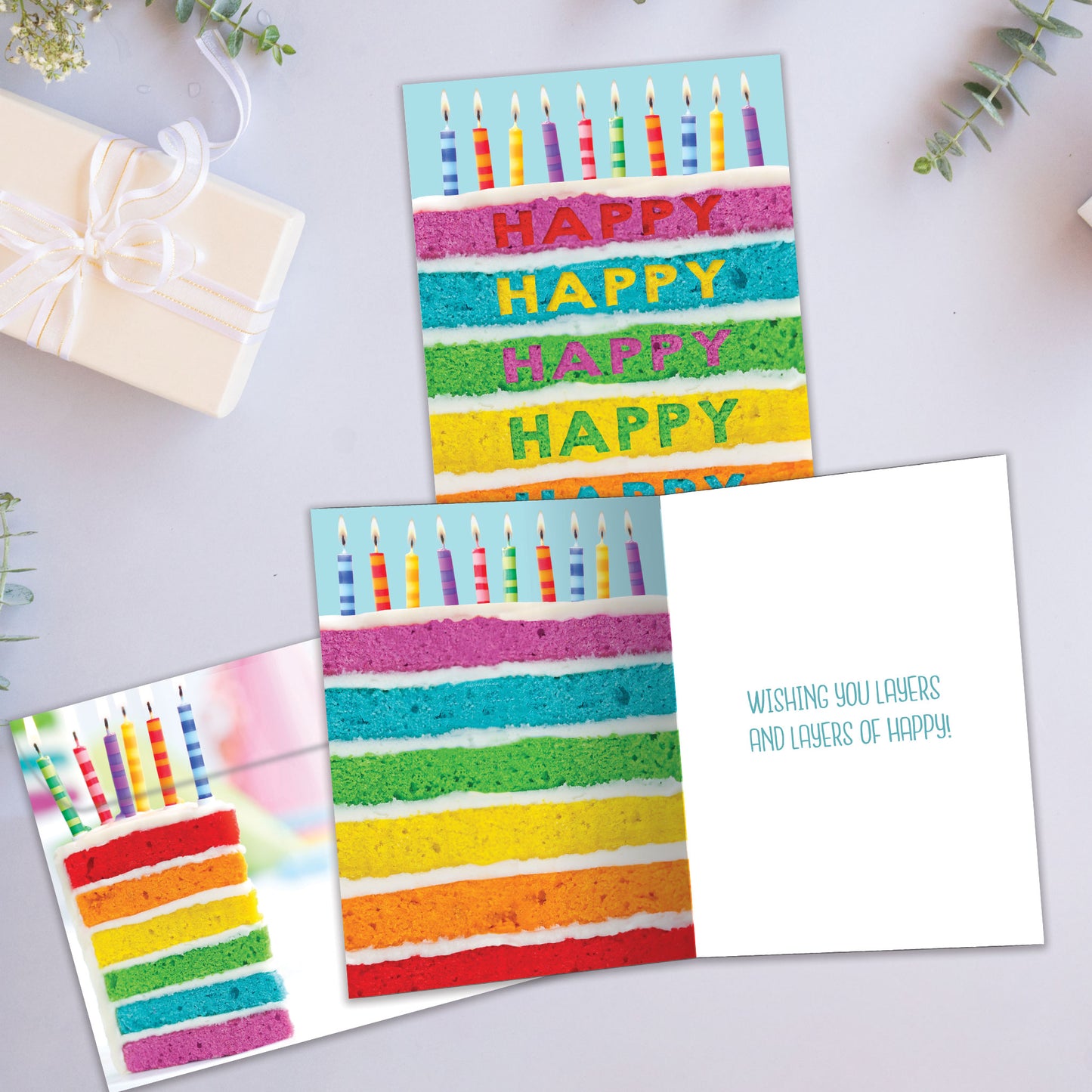 Front and inside view of a Birthday greeting card showcasing a slice of cake with colourful layers and birthday candles, with a matching envelope.