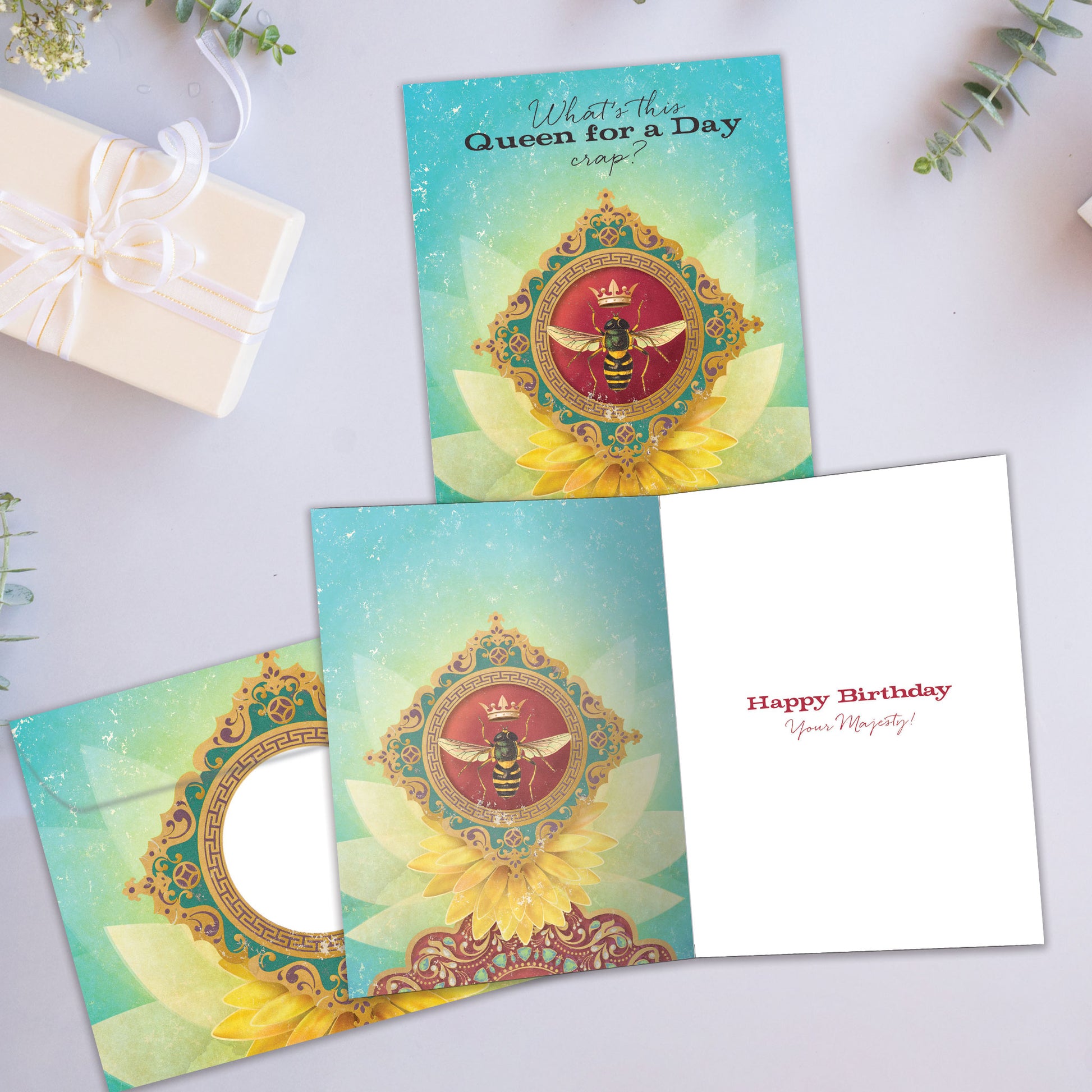 Front and inside view of a Birthday greeting card showcasing a Queen bee design with the message "queen for a day", with a matching envelope.