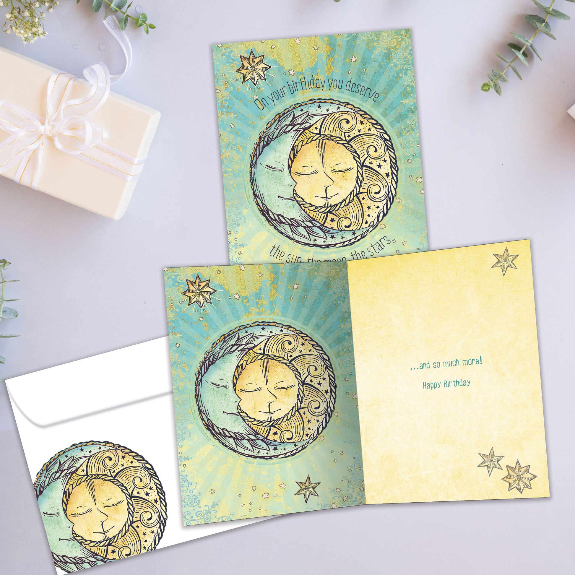 Front and inside view of a Birthday greeting card showcasing the sun, moon, and stars with a heartfelt message, with a matching envelope.