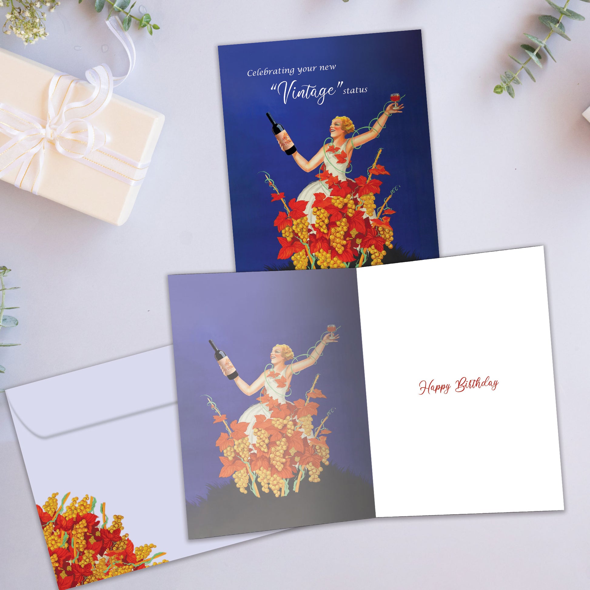 Front and inside view of a Birthday greeting card showcasing an illustration of a woman celebrating with wine and a message about vintage status, with a matching envelope.