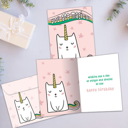 Front and inside view of a Birthday greeting card showcasing a unicorn cat with the words "you are magical" on a pink background, with a matching envelope.