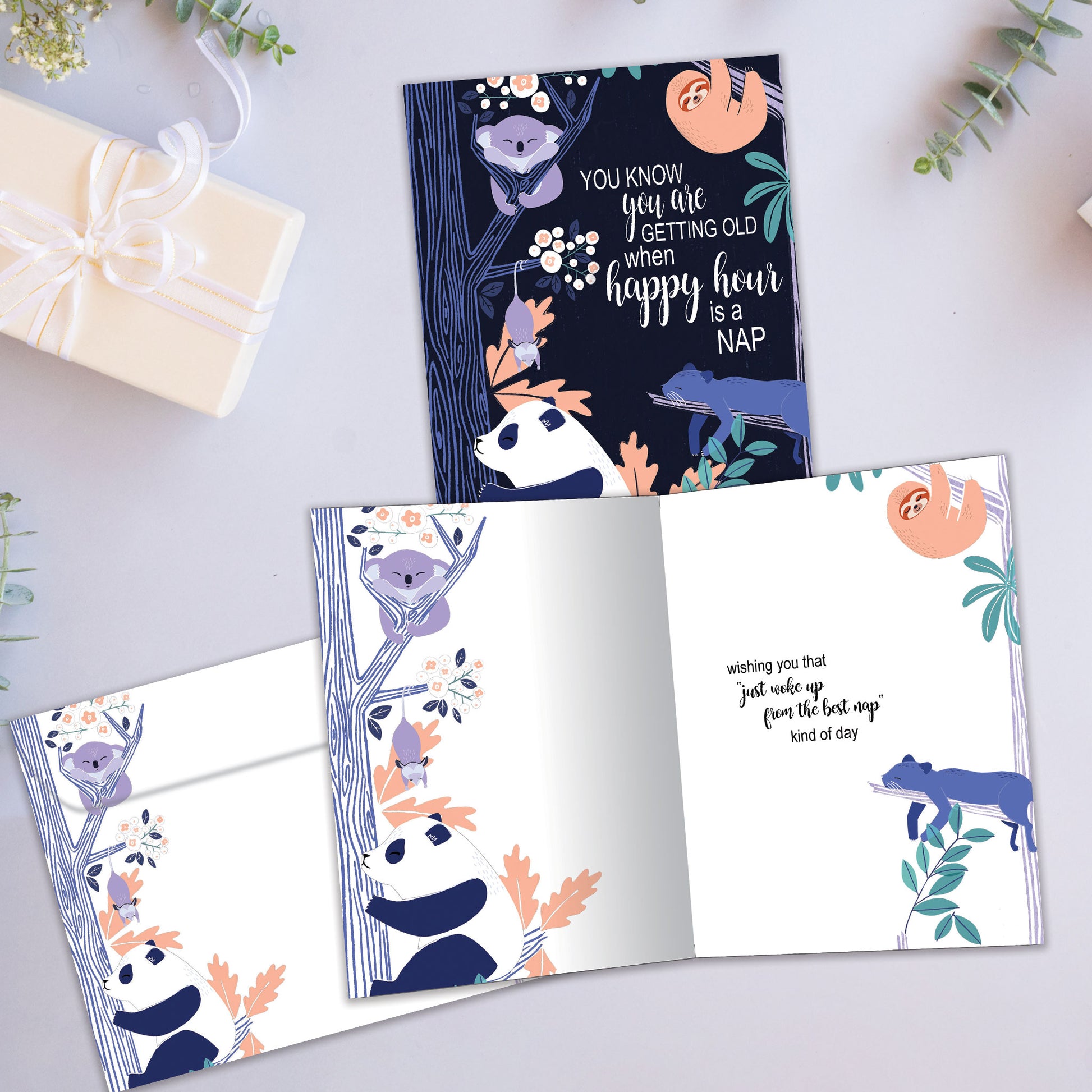 Front and inside view of a Birthday greeting card showcasing animals sleeping in trees with a message about getting old and napping, with a matching envelope.