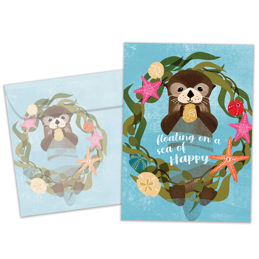 Front view of a Birthday greeting card featuring a floating sea otter with a happy message, with a matching envelope.