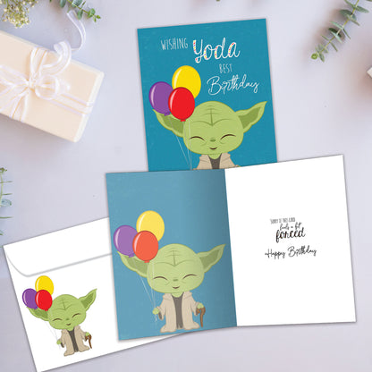 Front and inside view of a Birthday greeting card showcasing an illustration of Yoda holding balloons with a birthday message, with a matching envelope.