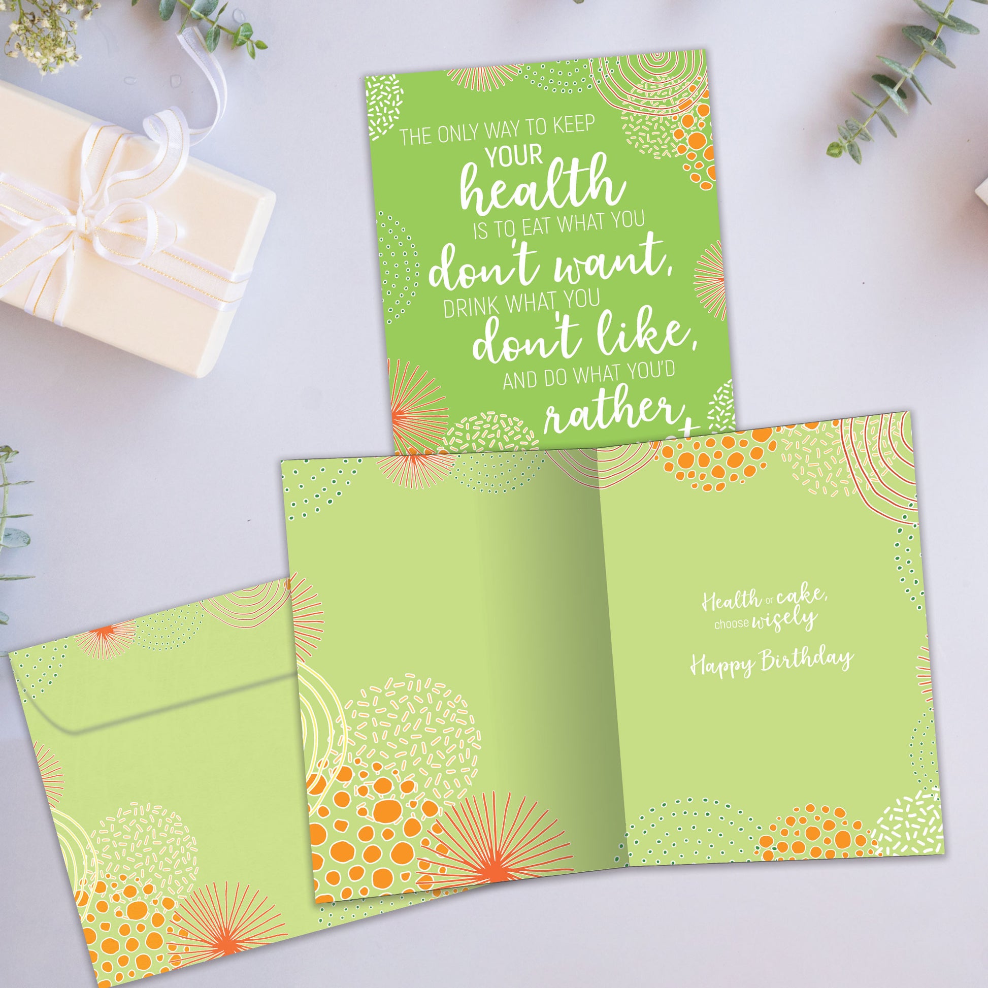 Front and inside view of a Birthday greeting card showcasing a green abstract background with a wise quote about life from Mark Twain, with a matching envelope.