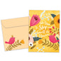 Front view of a Birthday greeting card featuring a bright floral design with a message about smelling the flowers, with a matching envelope.