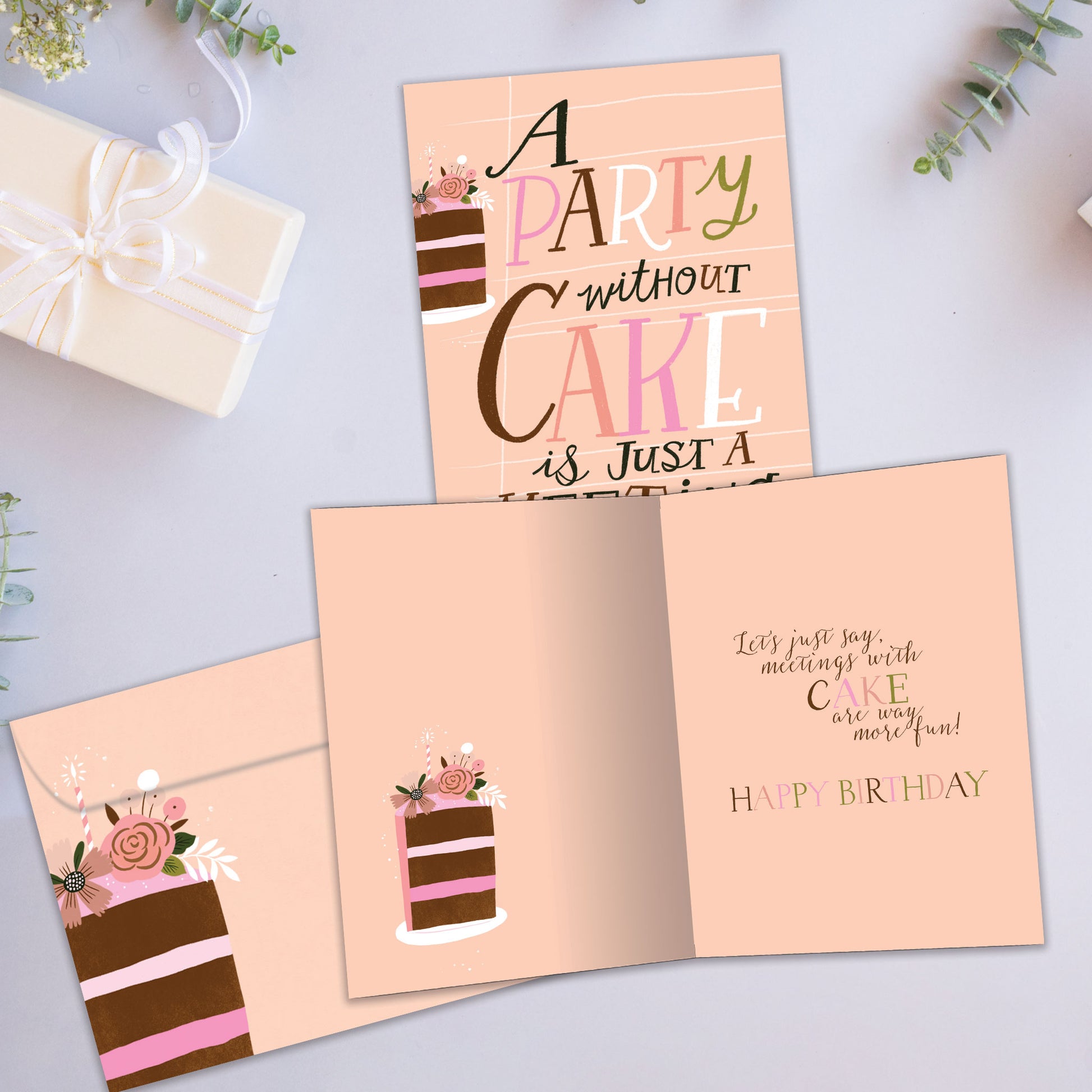 Front and inside view of a Birthday greeting card showcasing the words "A party without cake is just a meeting" on a peach background, with a matching envelope.