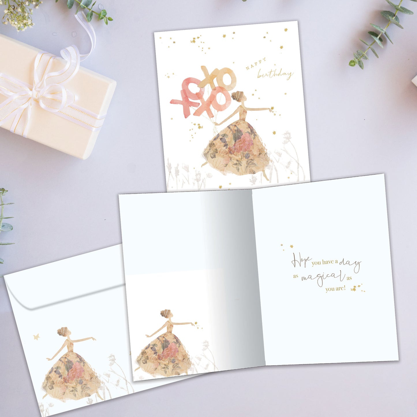 Front and inside view of a Birthday greeting card showcasing an illustration of a lady in a fancy gown with the message "happy birthday" and xoxo, with a matching envelope.