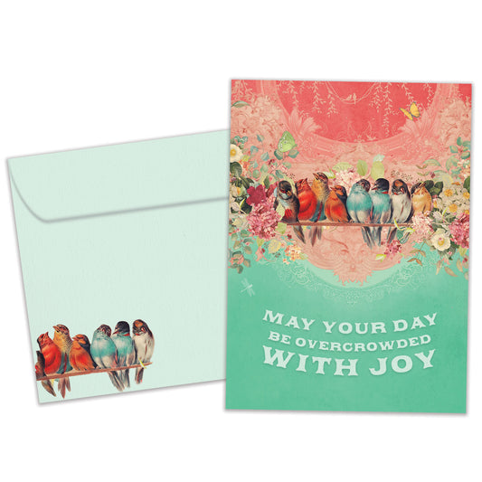 Front view of a Birthday greeting card featuring birds crowded on a branch with the message "may your day be overcrowded with joy", with a matching envelope.