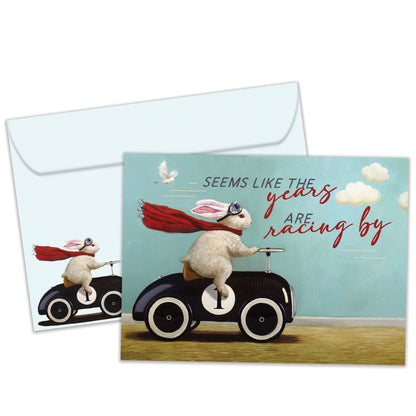Front view of a Birthday greeting card featuring a bunny in a car design with the message "the years racing by", with a matching envelope.
