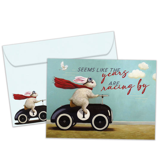 Front view of a Birthday greeting card featuring a bunny in a car design with the message "the years racing by", with a matching envelope.