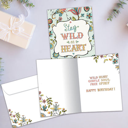 Front and inside view of a Birthday greeting card showcasing a floral design surrounding the words "stay wild at heart", with a matching envelope.