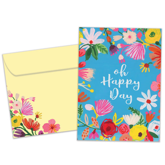 Front view of a Birthday greeting card featuring the message "oh happy day" surrounded by flowers on a baby blue background, with a matching envelope.