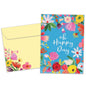 Front view of a Birthday greeting card featuring the message "oh happy day" surrounded by flowers on a baby blue background, with a matching envelope.