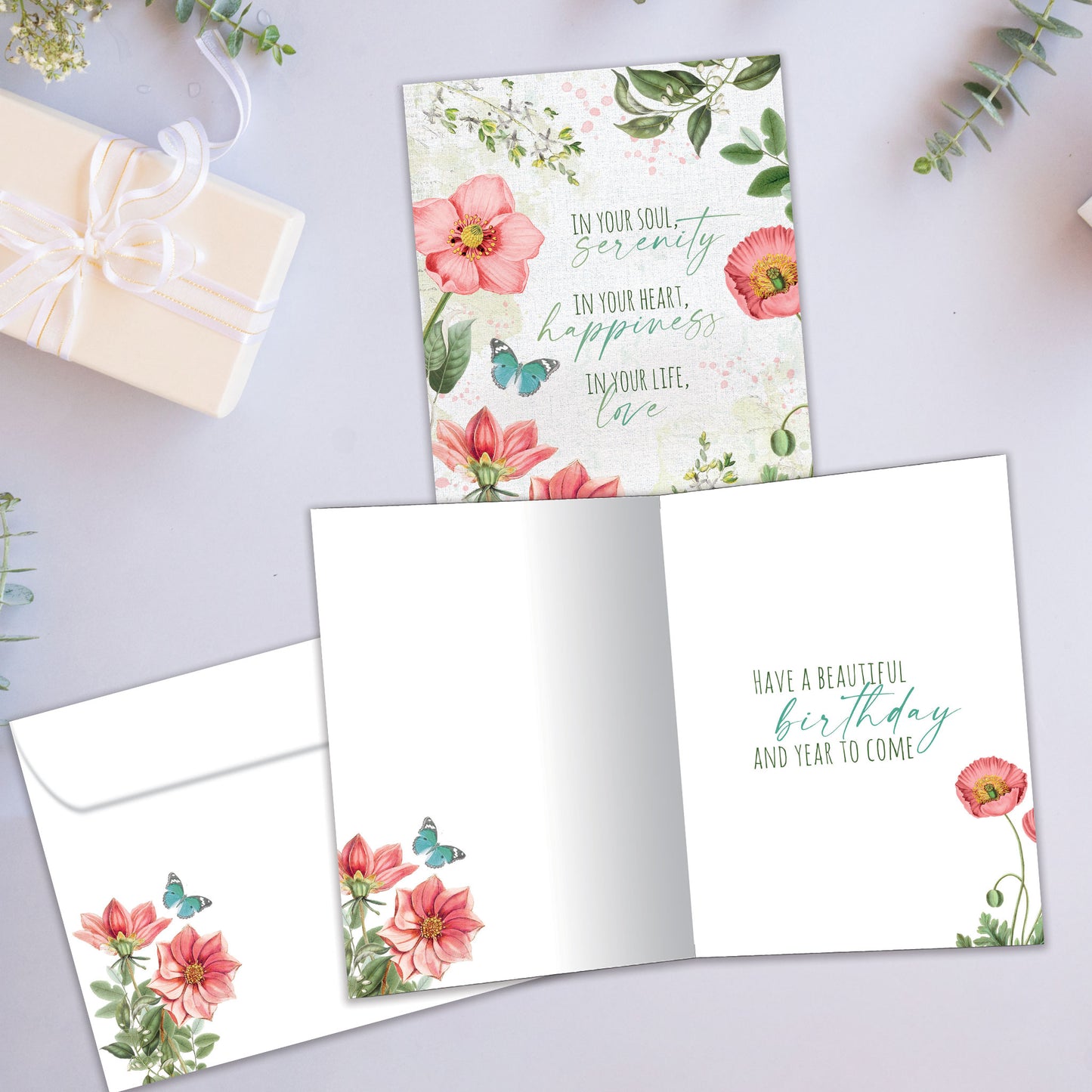 Front and inside view of a Birthday greeting card showcasing a floral design with a message about happiness and love, with a matching envelope.