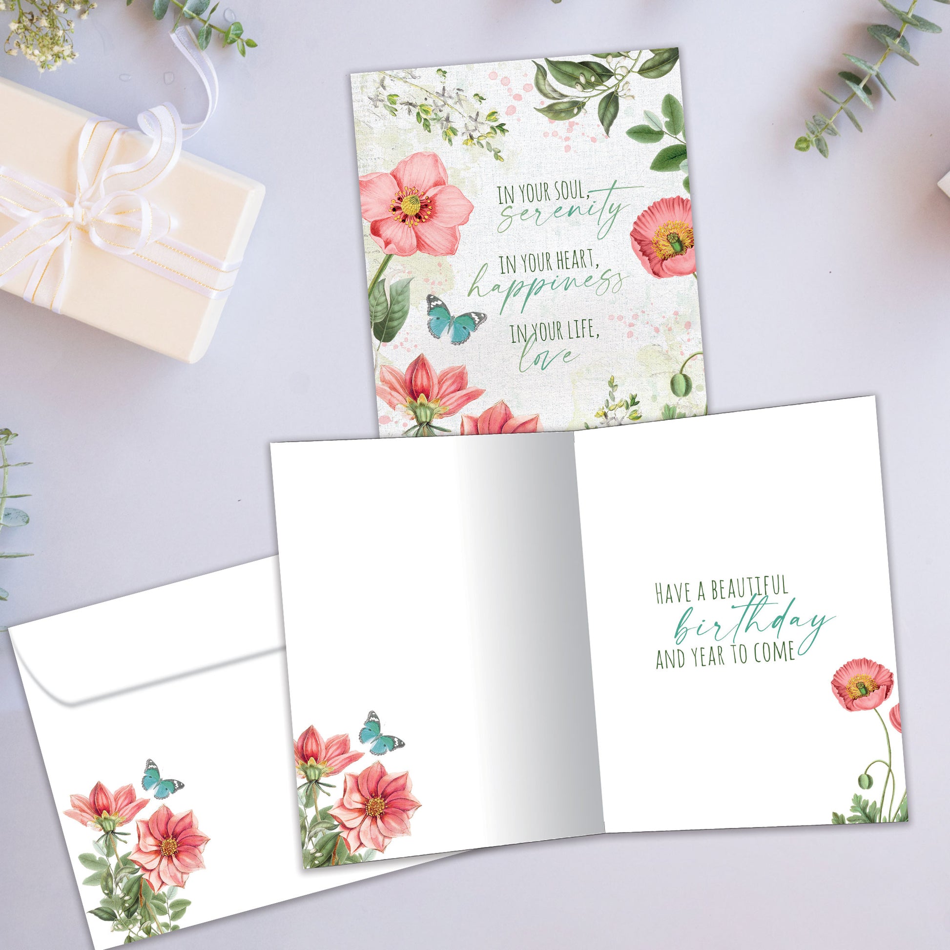 Front and inside view of a Birthday greeting card showcasing a floral design with a message about happiness and love, with a matching envelope.