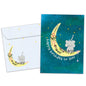Front view of a Birthday greeting card featuring an elephant sitting on the moon crescent with a happy birthday message, with a matching envelope.