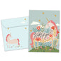 Front view of a Birthday greeting card featuring a pink unicorn with a magical message about believing, with a matching envelope.