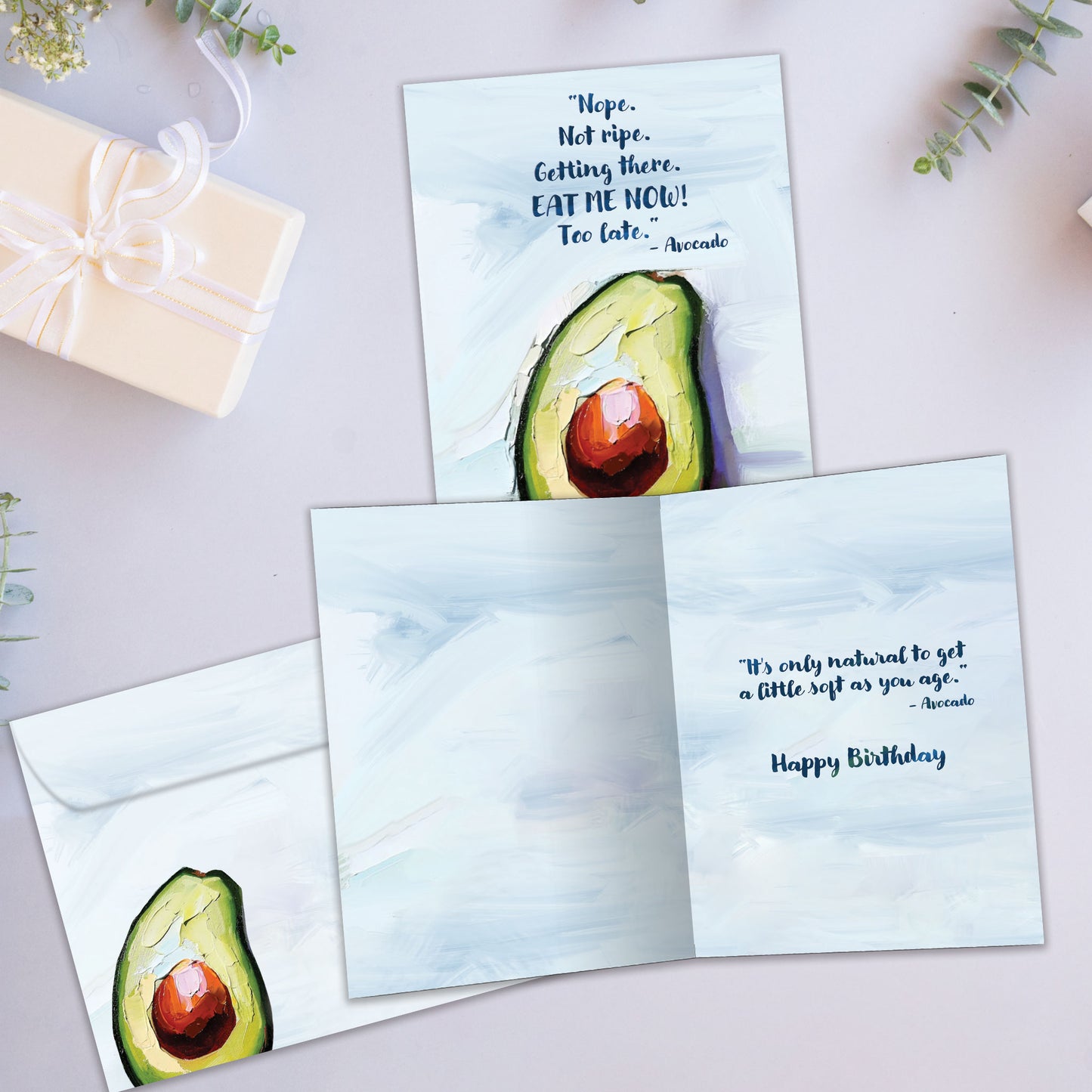 Front and inside view of a Birthday greeting card showcasing an avocado with a funny message about being ripe, with a matching envelope.