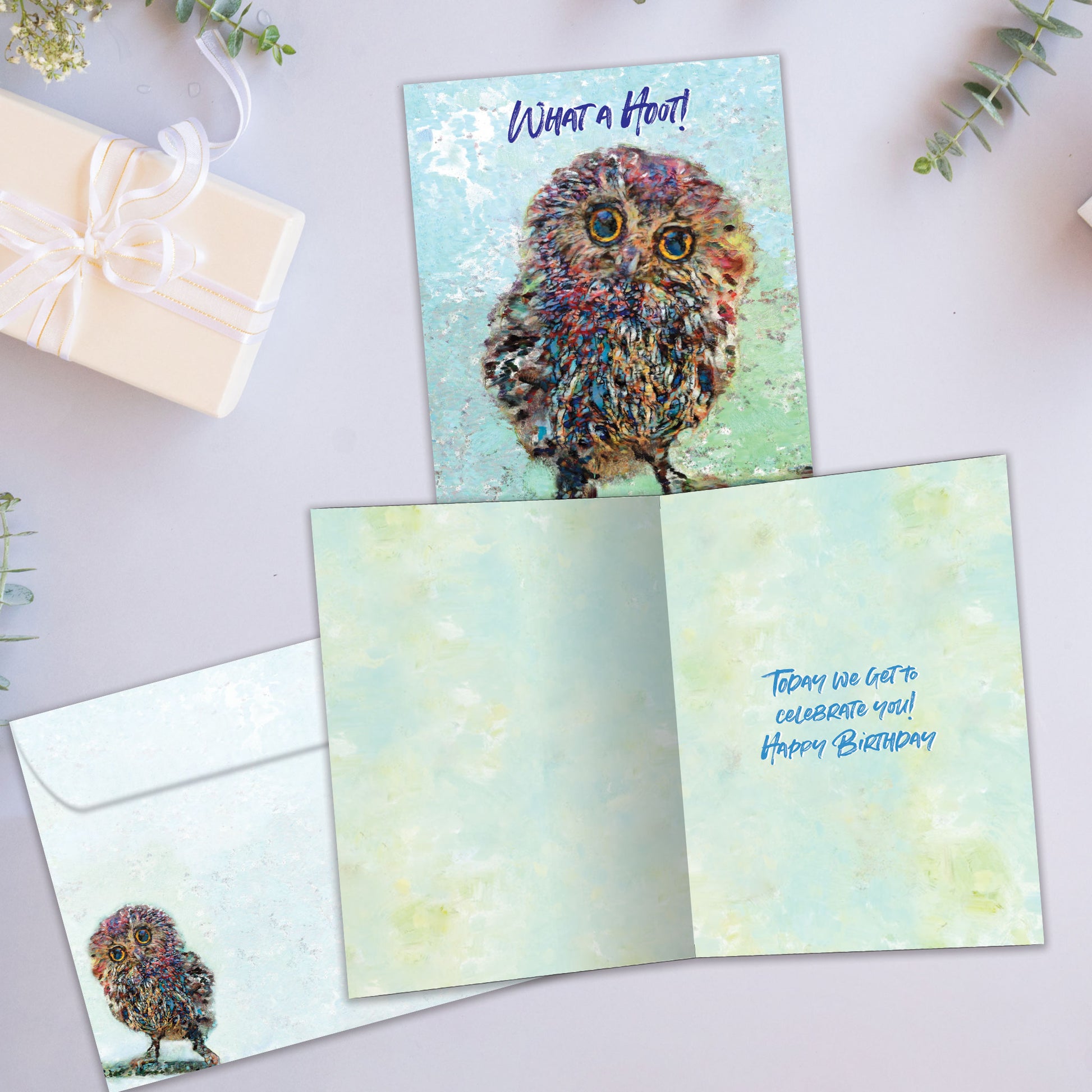 Front and inside view of a Birthday greeting card showcasing a colorful illustration of an owl with the message "what a hoot!", with a matching envelope.