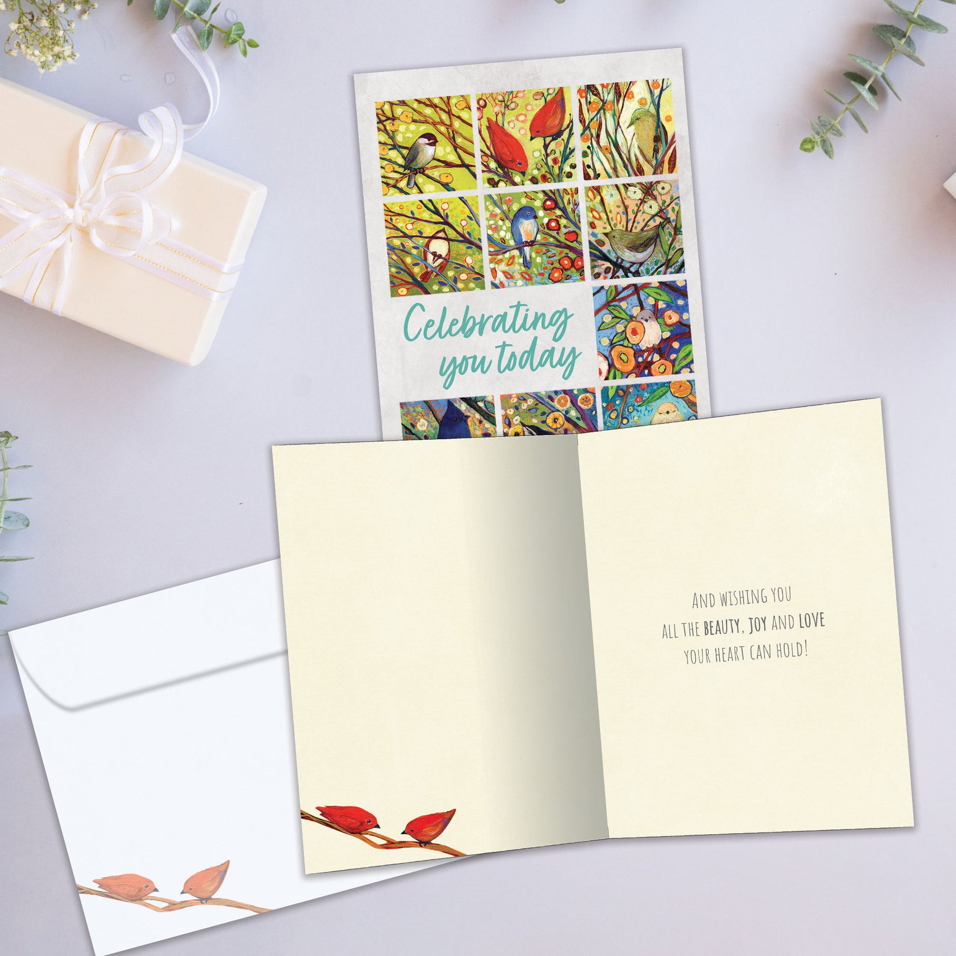 Front and inside view of a Birthday greeting card showcasing colorful birds and flowers with a celebration message, with a matching envelope.