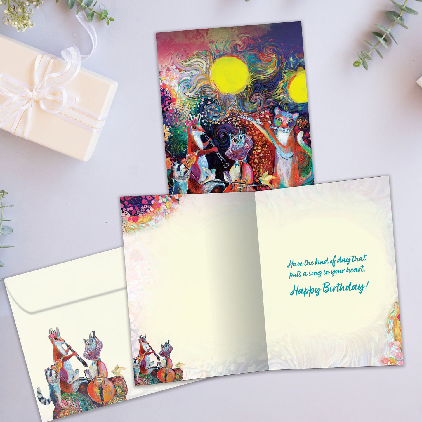 Front view of a Birthday greeting card with a vibrant illustration of musical animals, highlighting its eco-friendly materials and made in Canada.