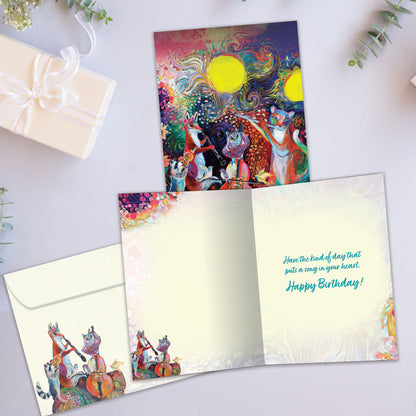 Front view of a Birthday greeting card with a vibrant illustration of musical animals, highlighting its eco-friendly materials and made in Canada.