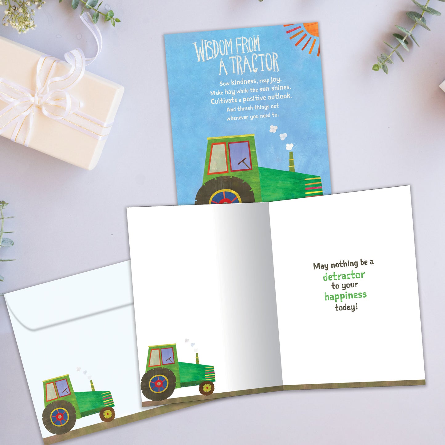 Front and inside view of a Birthday greeting card showcasing a tractor with words of wisdom, with a matching envelope.