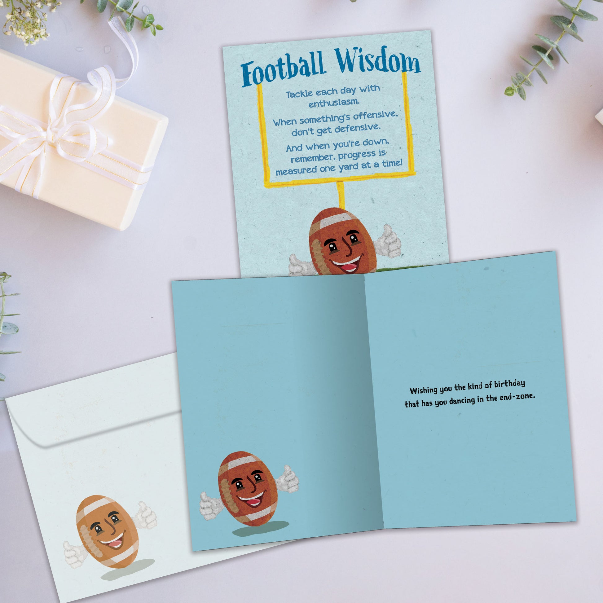 Front and inside view of a Birthday greeting card showcasing a smiling football with words of football wisdom, with a matching envelope.