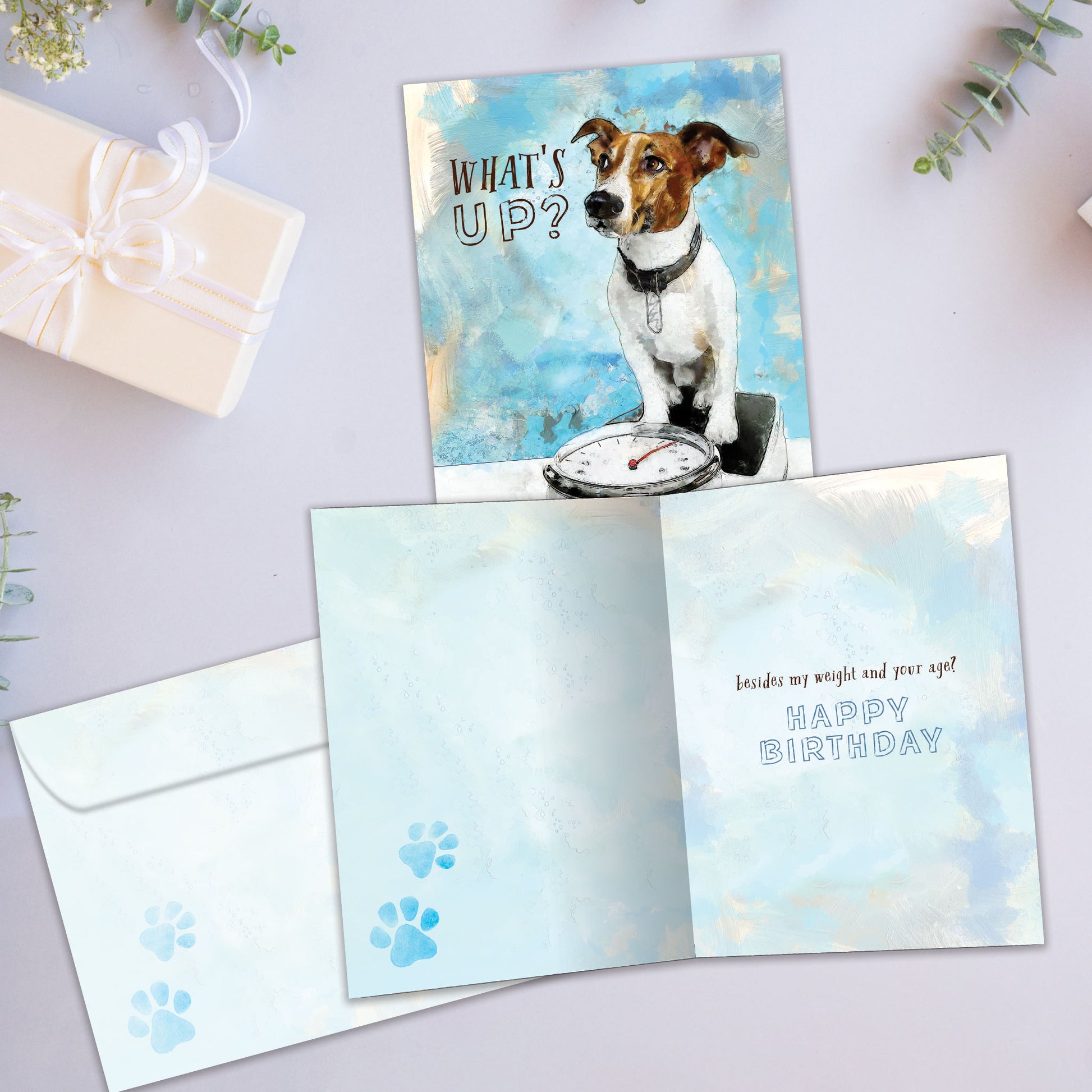 Front and inside view of a Birthday greeting card showcasing a dog on a scale with the words "what's up?", with a matching envelope.