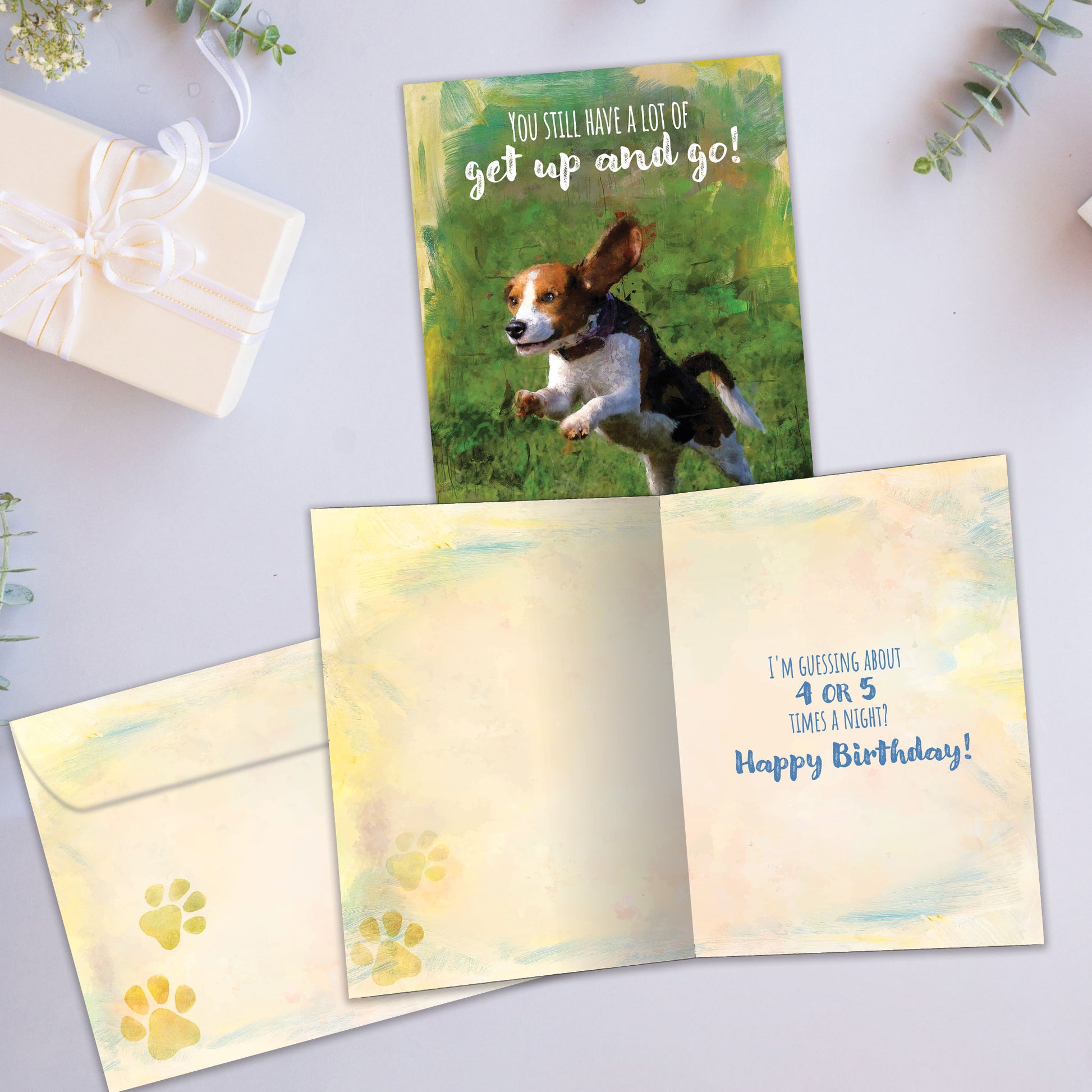 Front and inside view of a Birthday greeting card showcasing an illustration of a running dog with a message about having a lot of get up and go, with a matching envelope.