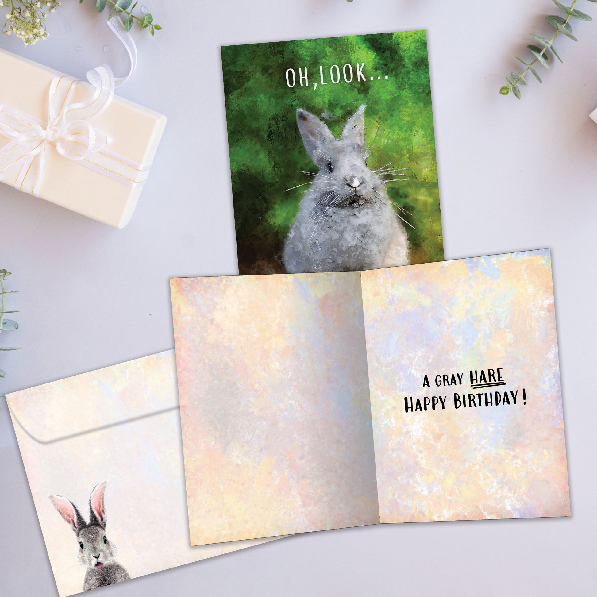 Front and inside view of a Birthday greeting card showcasing a bunny with the message "Oh, look...", with a matching envelope.