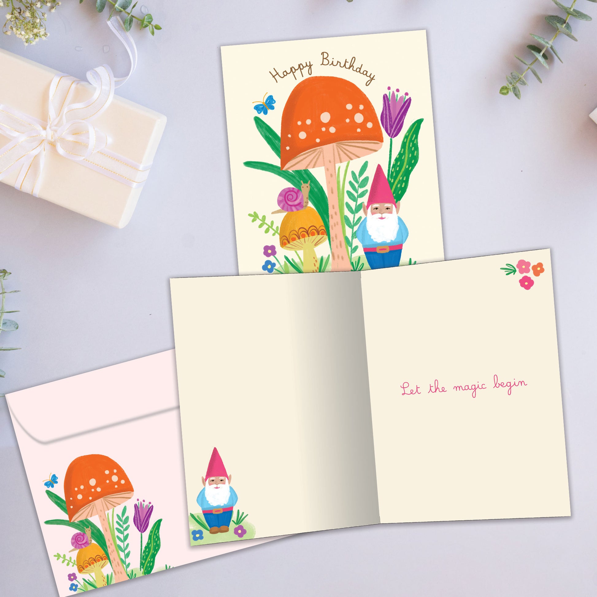 Front and inside view of a Birthday greeting card showcasing a colorful illustration of a gnome and mushroom, with a matching envelope.